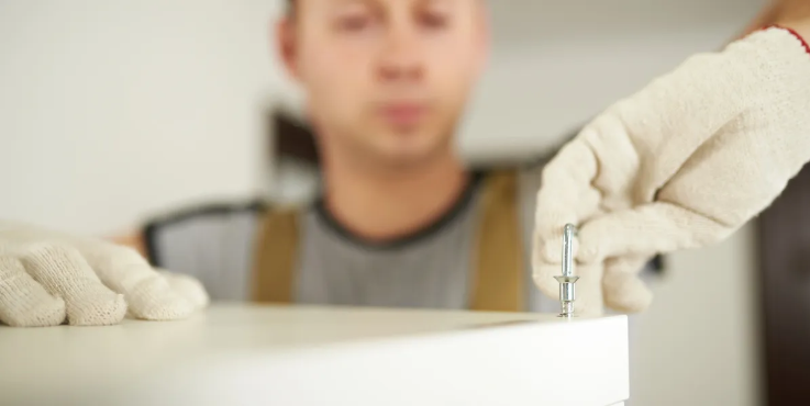 Close-up of precise hardware tightening during furniture assembly